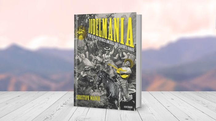 Das Buch „Christoph Wagner: Jodelmania - Von den Alpen nach Amerika und darüber hinaus“, ein 320-seitiges Buch in Hardcover-Einband auf einem Tisch stehend
